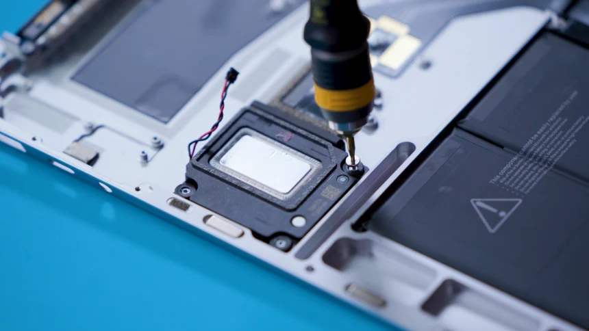 A screw being removed from a Surface Laptop 5