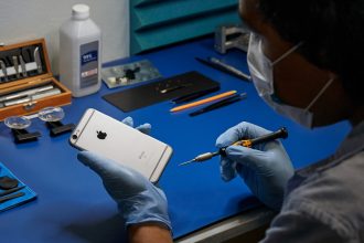 Someone beginning to repair an old iPhone.