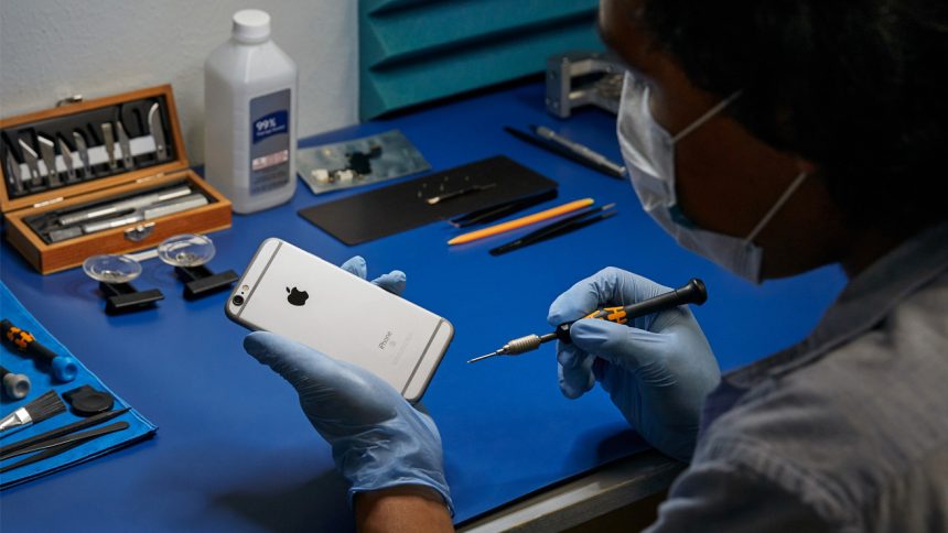 Someone beginning to repair an old iPhone.