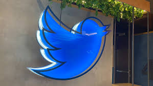 The Twitter logo on the side of a building.