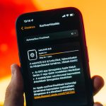 close up shot of a person holding a smartphone updating