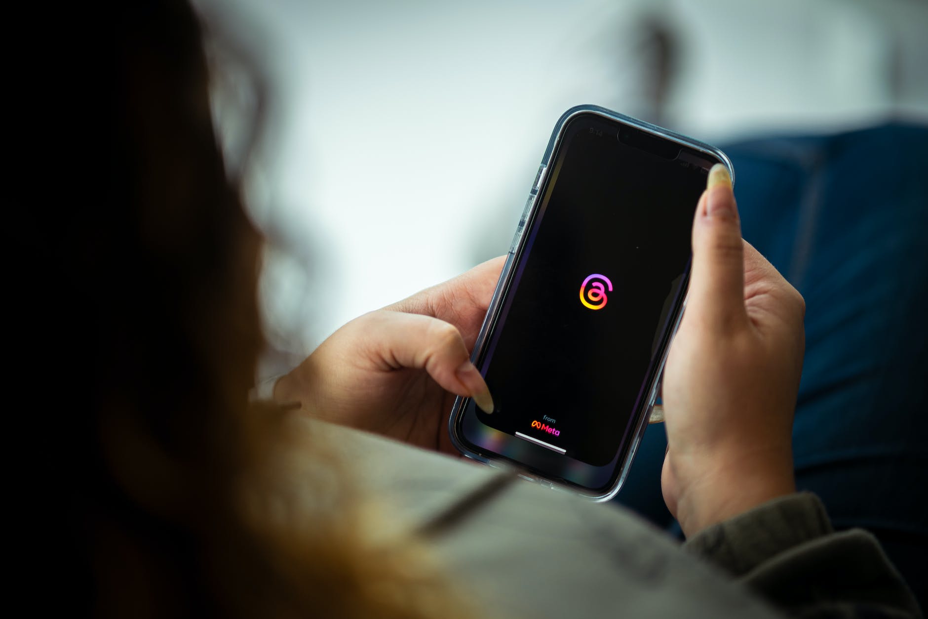 woman holding a smart phone and looking at a screen