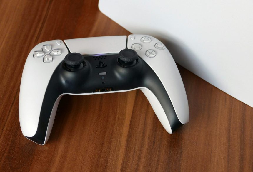 a white PlayStation 5 controller sitting on top of a white box