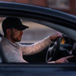A man configuring something on a screen in his Tesla