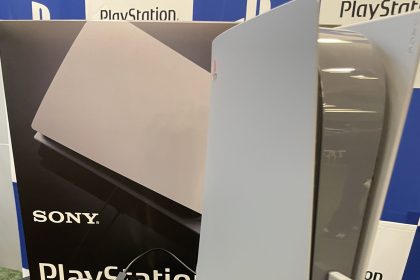 A PS5 and DualSense controller styled to look like a PS1