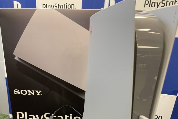 A PS5 and DualSense controller styled to look like a PS1