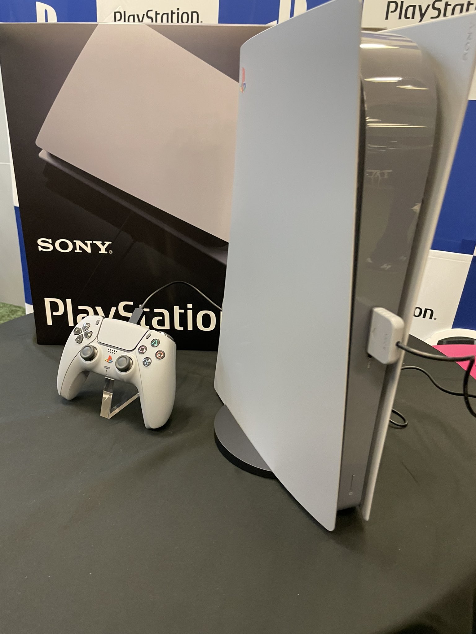A PS5 and DualSense controller styled to look like a PS1