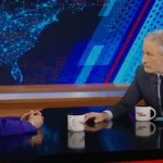 Jon Stewart (right) interviewing FTC Chair Lina Khan (left)