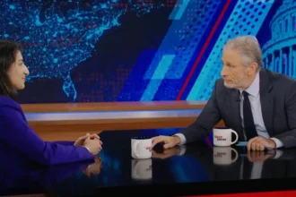 Jon Stewart (right) interviewing FTC Chair Lina Khan (left)